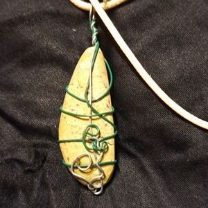 Polished limestone in green wire wrap w/20 in nylon cord